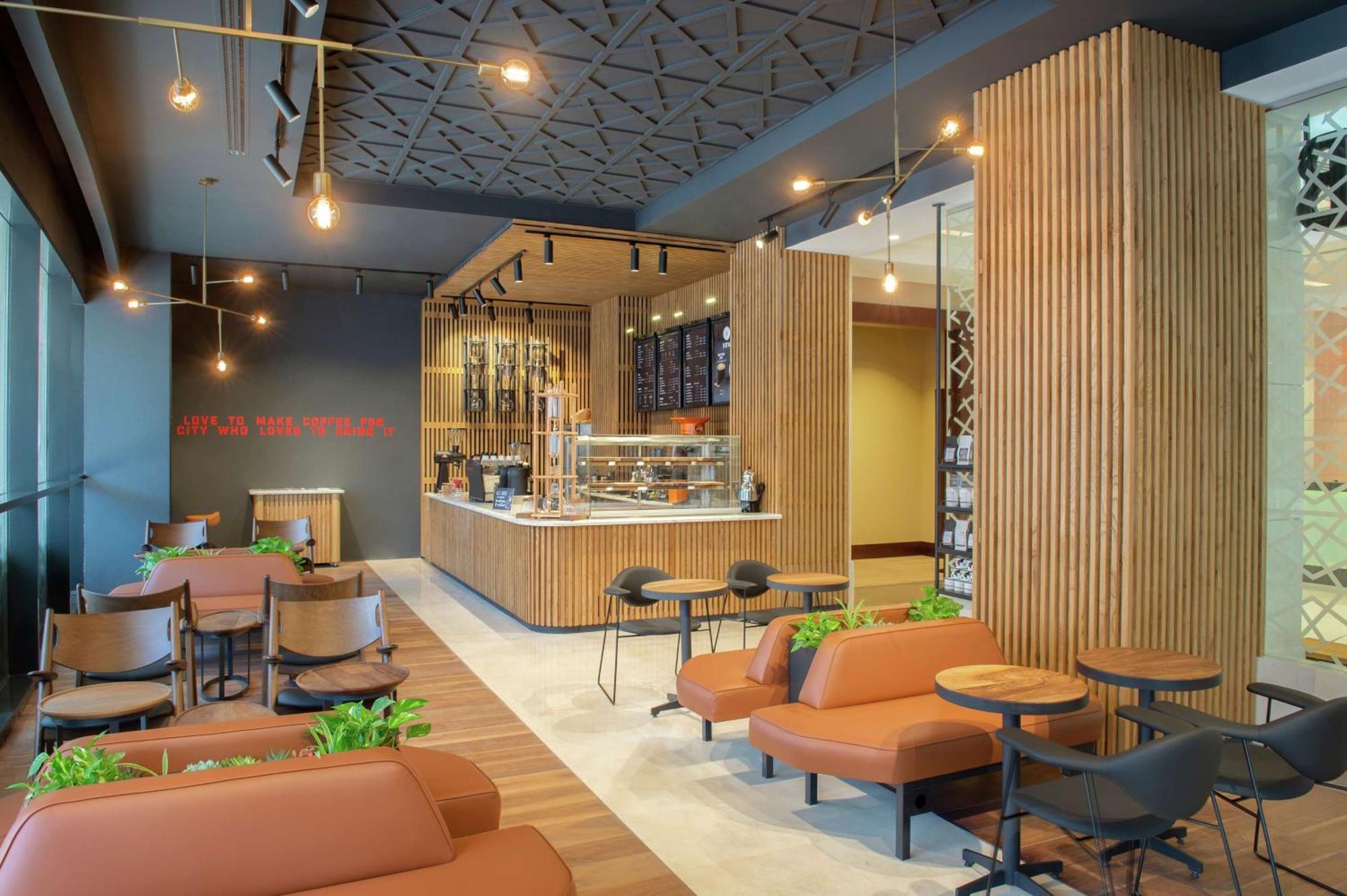 فندق دبل تري باي هيلتون الدوحة - آل ساد المظهر الخارجي الصورة Interior of a Starbucks Reserve store in Seoul, South Korea